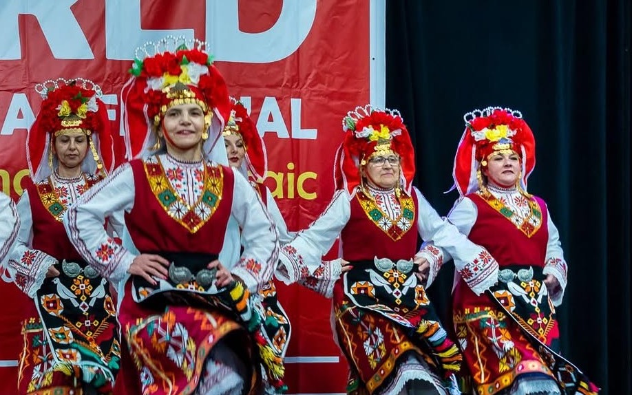 Rodina dancers performing synchronized steps on the World Multicultural Festival stage