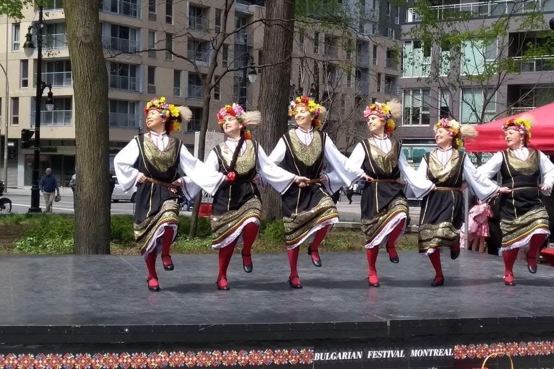 Rodina dancers caught mid-step in Bulgarian folk costumes at the Bulgarian Multicultural Festival in Montreal